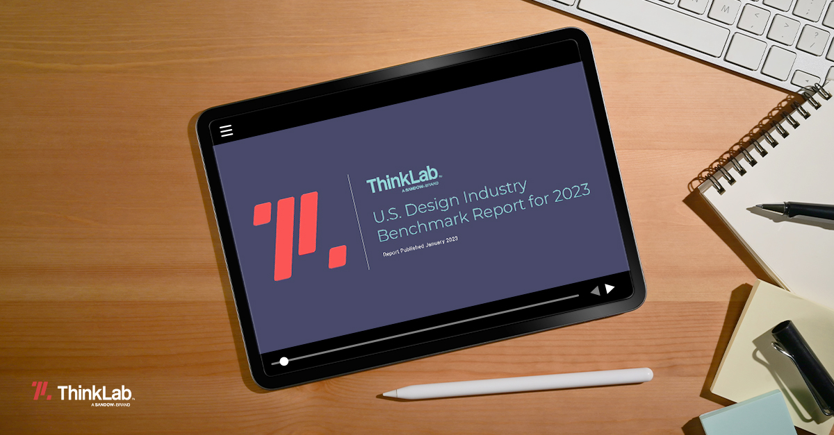 An ipad displaying the text "U.S Design Industry Benchmark Report for 2023